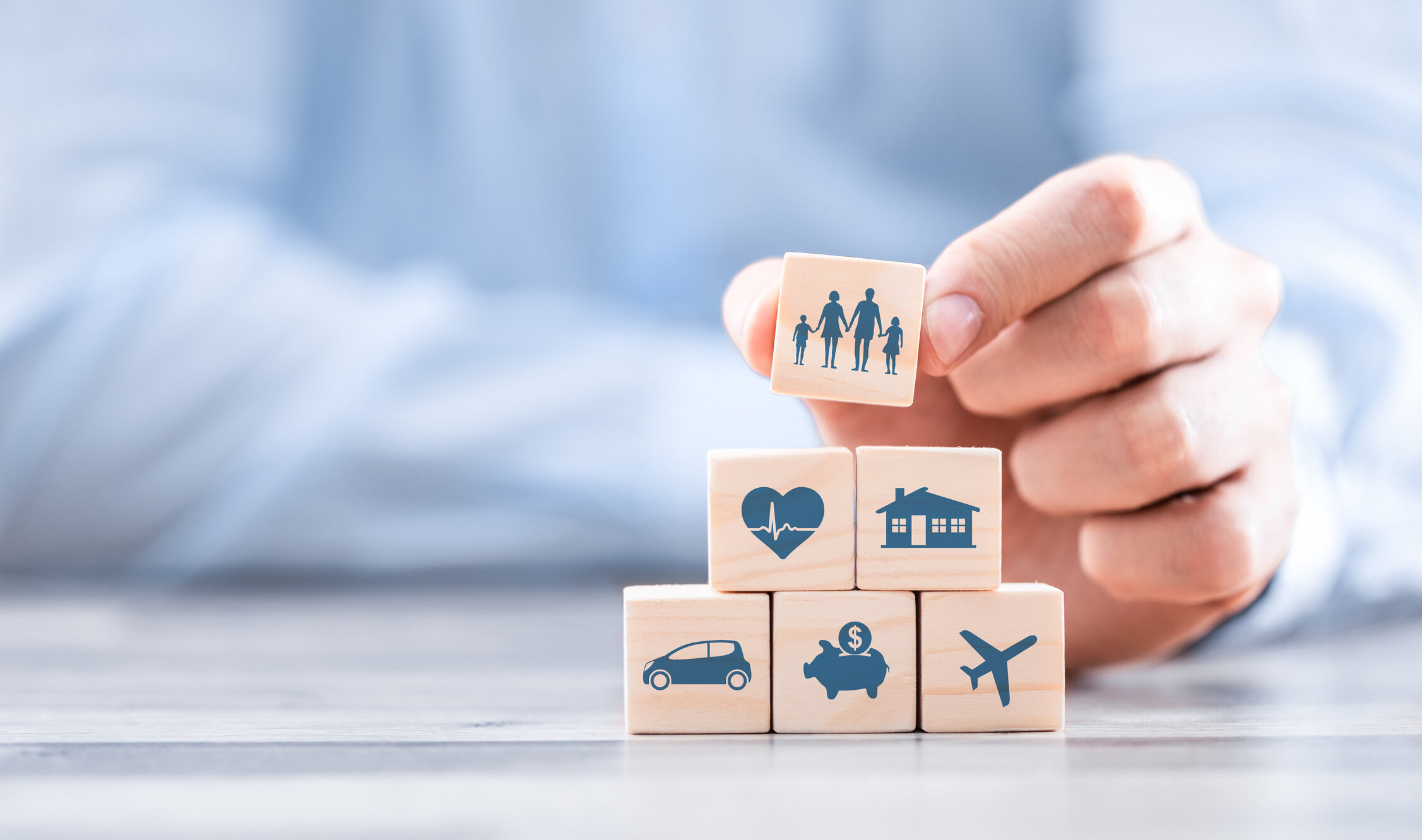 Wooden blocks with icons of various types of insurance. Life insurance concept.